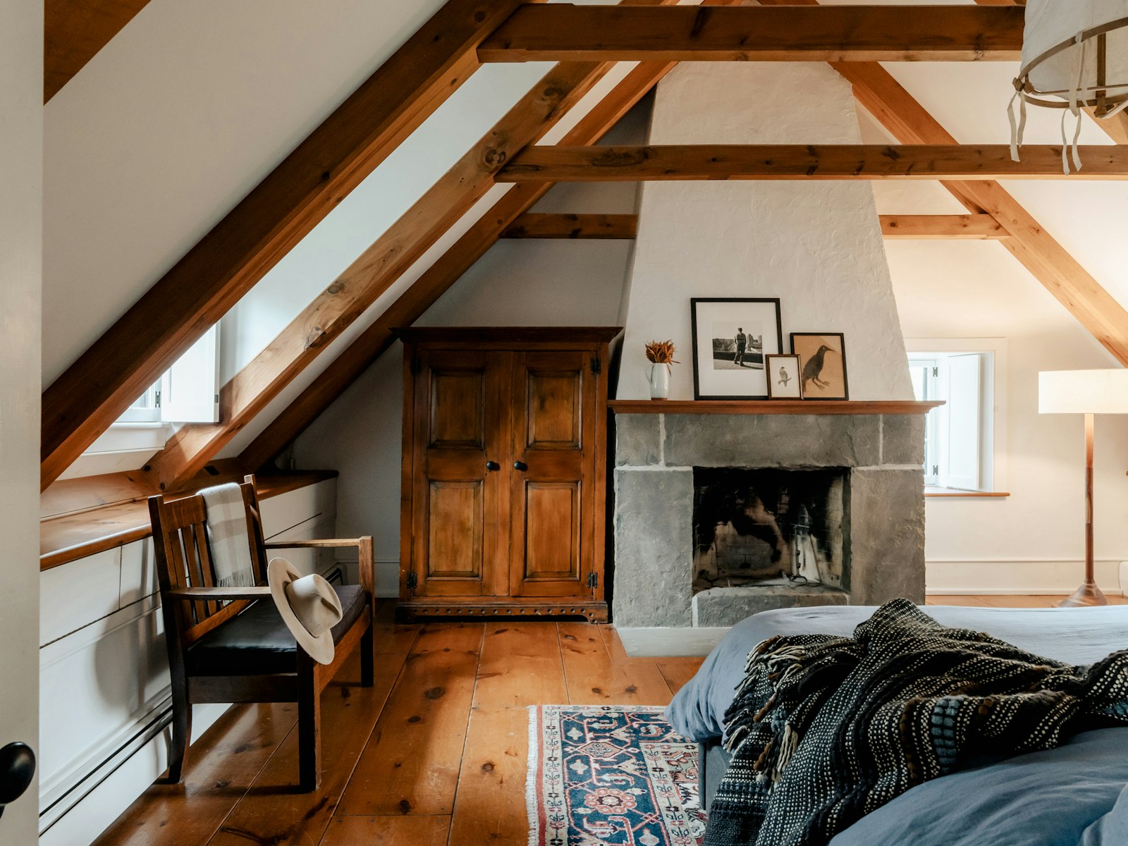 The Eaves, sloping beamed ceiling above a dormer window and a stone hearth