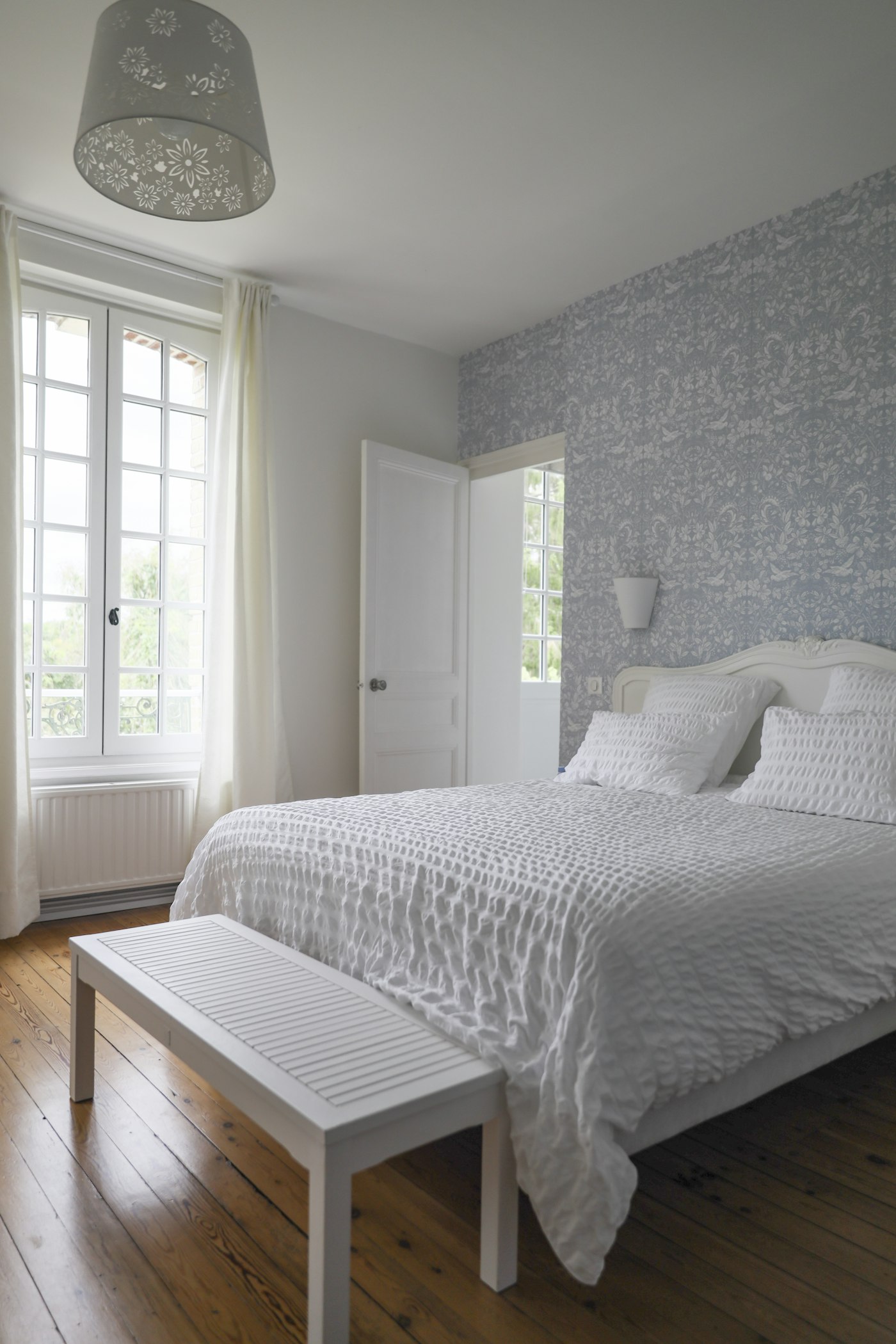The Garden Room, bed beside tall doors open onto the walled garden